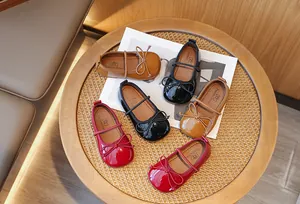 Top view of patent leather Mary Jane shoes for girls with elegant bow accents