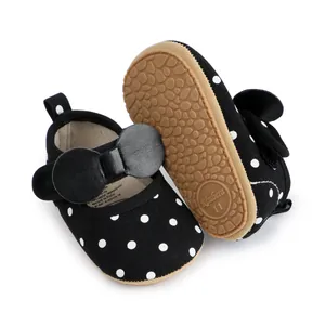 Chaussures de marche bébé fille à pois avec nœud noir et semelle en caoutchouc souple