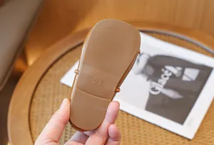 Detail showing the anti-slip soft rubber sole and size marking of the girl's shoe.