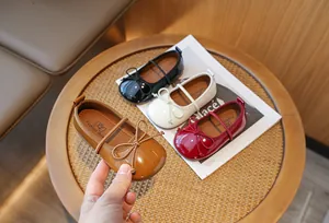 Detail showing girls' patent leather bow Mary Jane princess shoes in multiple colors