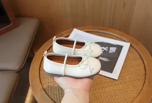 Elegant cream white Mary Jane shoes for girls with delicate bow detail and soft sole