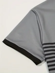 Close-up detail of grey breathable fabric and black stripes on a casual men's polo shirt.