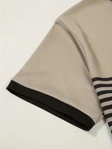 Close-up detail of a men's polo shirt sleeve with black ribbed cuff and striped pattern