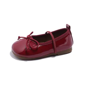 Elegant burgundy patent leather girls' flats with bow detail and comfortable soft sole