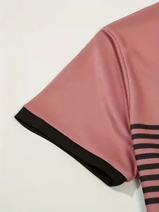 Close-up detail of the short sleeve and black ribbed cuff of a pink striped polo shirt