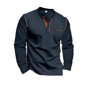 Close-up of navy blue long sleeve Henley shirt featuring stylish brown color-block trim.