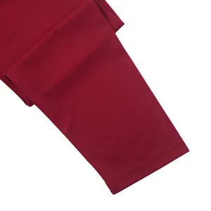 Close-up of the double-stitched hem on a maroon knit long-sleeved Henley shirt