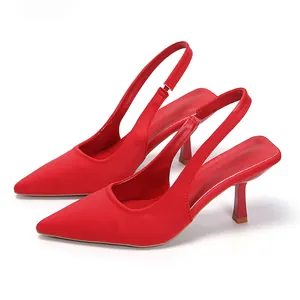 Elegant red pointed-toe slingback pumps featuring a sleek kitten heel and satin-like finish.