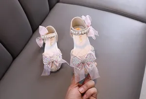 Elegant pink girls' princess shoes with sparkly rhinestone bows and pearl straps
