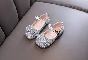 Detailed view of sparkling silver girls princess shoes with pearl straps and bow