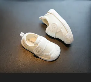 Close-up view of white toddler indoor shoes featuring breathable mesh and velcro strap