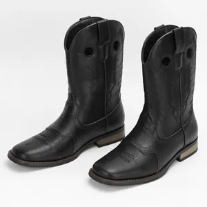 Close-up of black vintage embroidered men's Western cowboy boots with square toe.