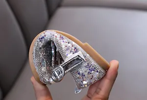 Close-up showing the soft flexible sole of girls silver glitter princess shoes