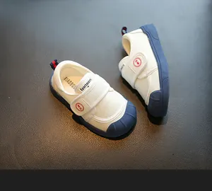 Detailed view of white and blue soft sole canvas shoes for children and toddlers