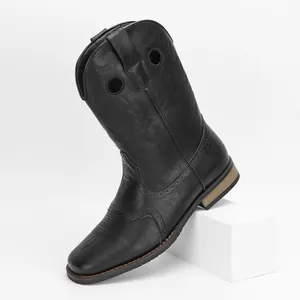 Detail view of vintage black men's western cowboy boots with embroidery and perforated accents