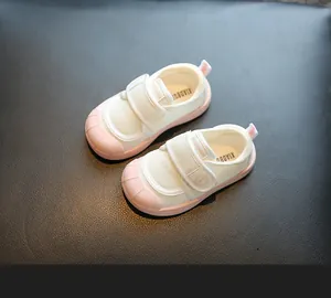 Detailed view of pink and white soft sole baby indoor shoes featuring breathable mesh fabric