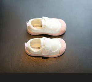 Top view of baby canvas shoes featuring soft pink soles and convenient velcro straps