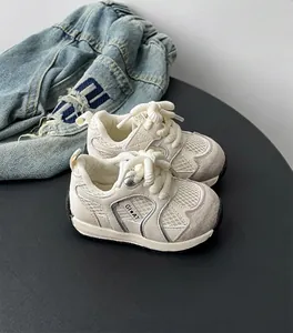 Detailed macro view of cream toddler mesh sneakers with breathable texture and soft soles