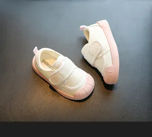 Macro detail of white toddler indoor shoes with breathable mesh and soft pink soles