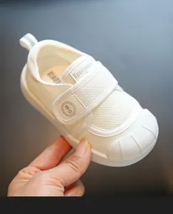 Close-up view of breathable white baby indoor shoe featuring mesh upper and soft sole