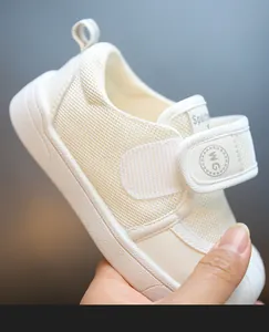 Detail view of breathable white mesh toddler sneaker with velcro strap and soft sole