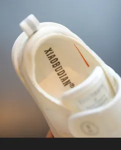 Detail view of white toddler indoor shoes showing the soft insole and inner lining texture.