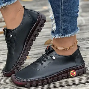 Detail of handmade black flat casual shoes with soft textured sole and stitching.