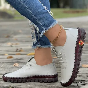 Side view of comfortable white leather loafers with hand-stitched details and soft gum sole