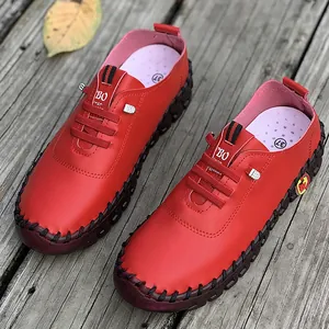 Casual red women's loafers with hand-stitched detailing on soft rubber soles
