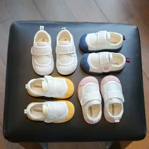Collection of soft sole toddler canvas shoes in blue, pink, yellow, and white colors