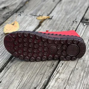 Close-up of durable brown beef tendon sole with massage dots for red women's flats.