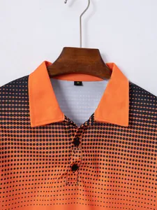 Close-up detail showing the orange collar and black polka dot pattern of the polo shirt