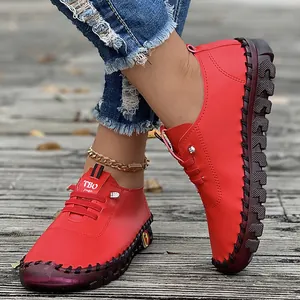 Detailed view of women's red handmade leisure flats with soft beef tendon soles