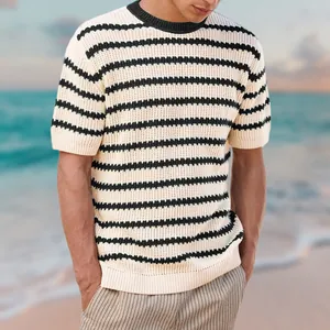 Detailed view of a man wearing a stylish striped short-sleeve knit sweater at the beach