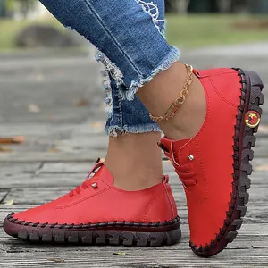 Close-up view of red soft leather women's flat shoes with exquisite hand-stitched detailing