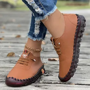 Detail view of brown hand-stitched women's casual flat shoes with durable soft soles