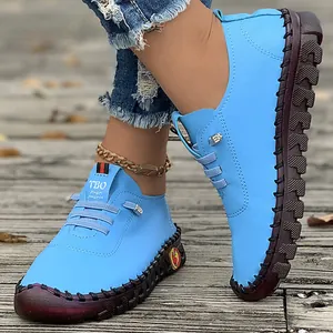Detail view of women's bright blue handmade casual flat shoes with soft tendon soles