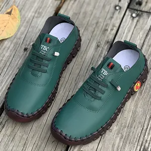 Macro detail of dark green handmade leather loafers with soft rubber sole for women