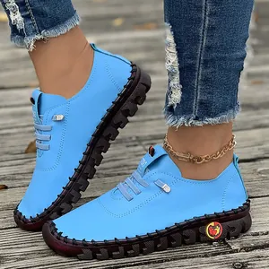Close-up of bright blue handmade soft sole women's casual loafers on wooden deck