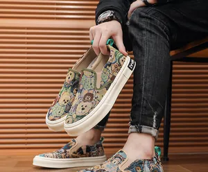 Close-up of men's slip-on canvas shoes featuring a vibrant cartoon bear pattern design.