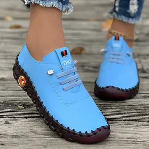 Close-up view of light blue handmade leather loafers for women with soft rubber sole