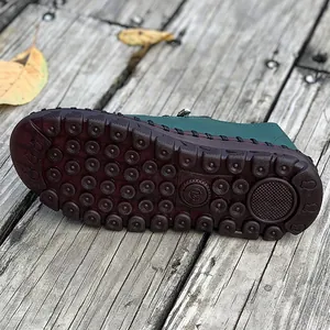Close-up view of a durable brown rubber sole with traction pattern on handmade flat shoes