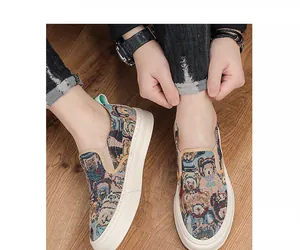 Detail of men's casual slip-on shoes with vintage cartoon bear tapestry pattern.