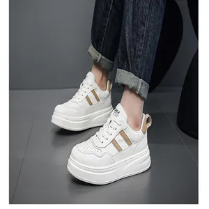 Detailed close-up shot of men's stylish white leather platform sneakers on feet