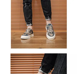 Detail view of men's canvas shoes featuring a playful cartoon bear pattern on denim jeans