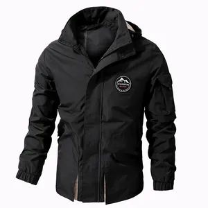 Black men's outdoor windbreaker jacket with detachable hood and mountain patch emblem