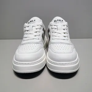 Front view of men's white leather platform sneakers with GAGJ branding