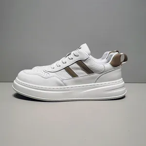 Men's white leather casual sneakers with brown diagonal bars and thick sole.
