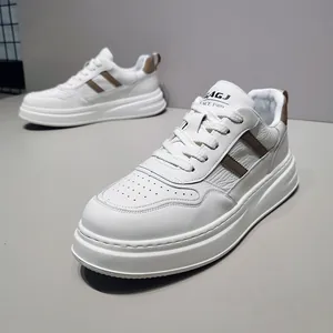 Close-up of men's white leather board shoes with brown diagonal stripe and thick sole