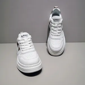 Top-down view of white thick-soled men's casual sneakers with side stripe details